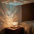 Crystal water-ripple lamp glowing warm amber and teal in a cozy bedroom at night