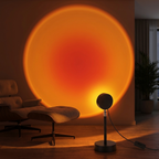 Sunset projection lamp casting a warm orange sun halo on a living room wall at dusk
