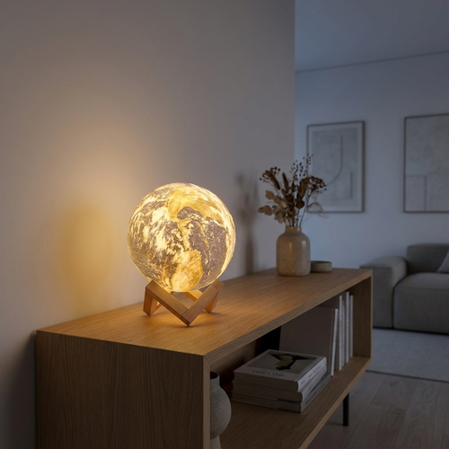 3D printed moon earth globe lamp glowing warm on a minimal styled console shelf