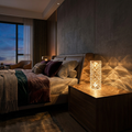 Rose diamond faceted LED table lamp glowing warm on a moody bedside table