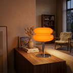 Mid-century glass table lamp with white glass shade glowing in a cozy living room