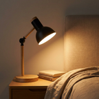 Wood-and-metal dome bedside lamp glowing warm in a modern Scandinavian bedroom at night