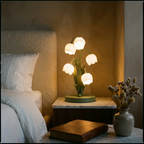 French bell orchid table lamp glowing warm on a nightstand in an elegant bedroom