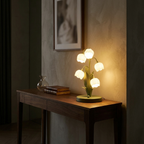 French bell orchid table lamp glowing warm on a console in a moody living room