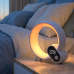 AuraDawn sunrise alarm clock glowing warm on a nightstand at dawn