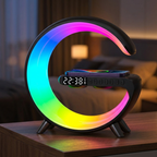 AuraHub 3-in-1 wireless charger desk lamp in black with RGB rainbow light bar and digital clock on a walnut bedside table